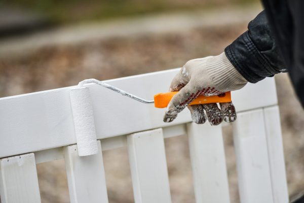 man-paints-garden-furniture-white-with-a-paint-rol-2024-12-07-12-23-17-utc