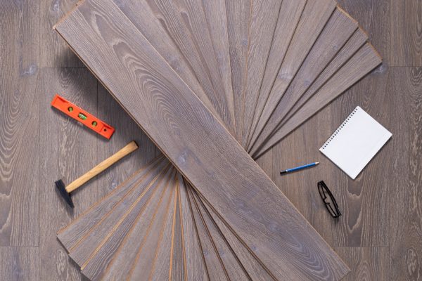 Wood laminate floor and tools background texture. Wooden laminate floor with tool